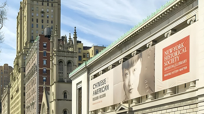 New York Historical Society building with exhibition banners and city street.