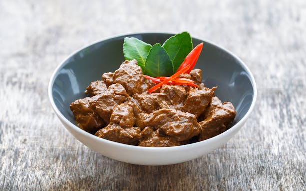 Beef rendang dish with chili and lime leaves, featured on Kuala Lumpur nightlife food tour.