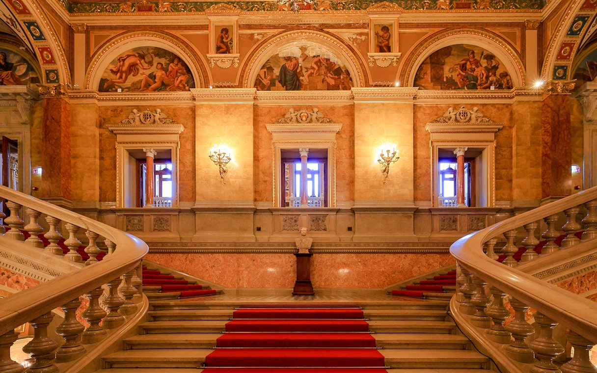 Grand staircase and ornate hallway inside the Hungarian State Opera, Budapest.