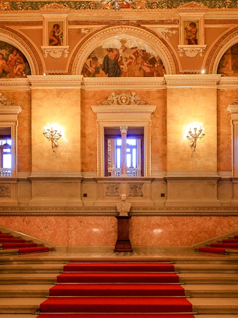 Grand staircase and ornate hallway inside the Hungarian State Opera, Budapest.