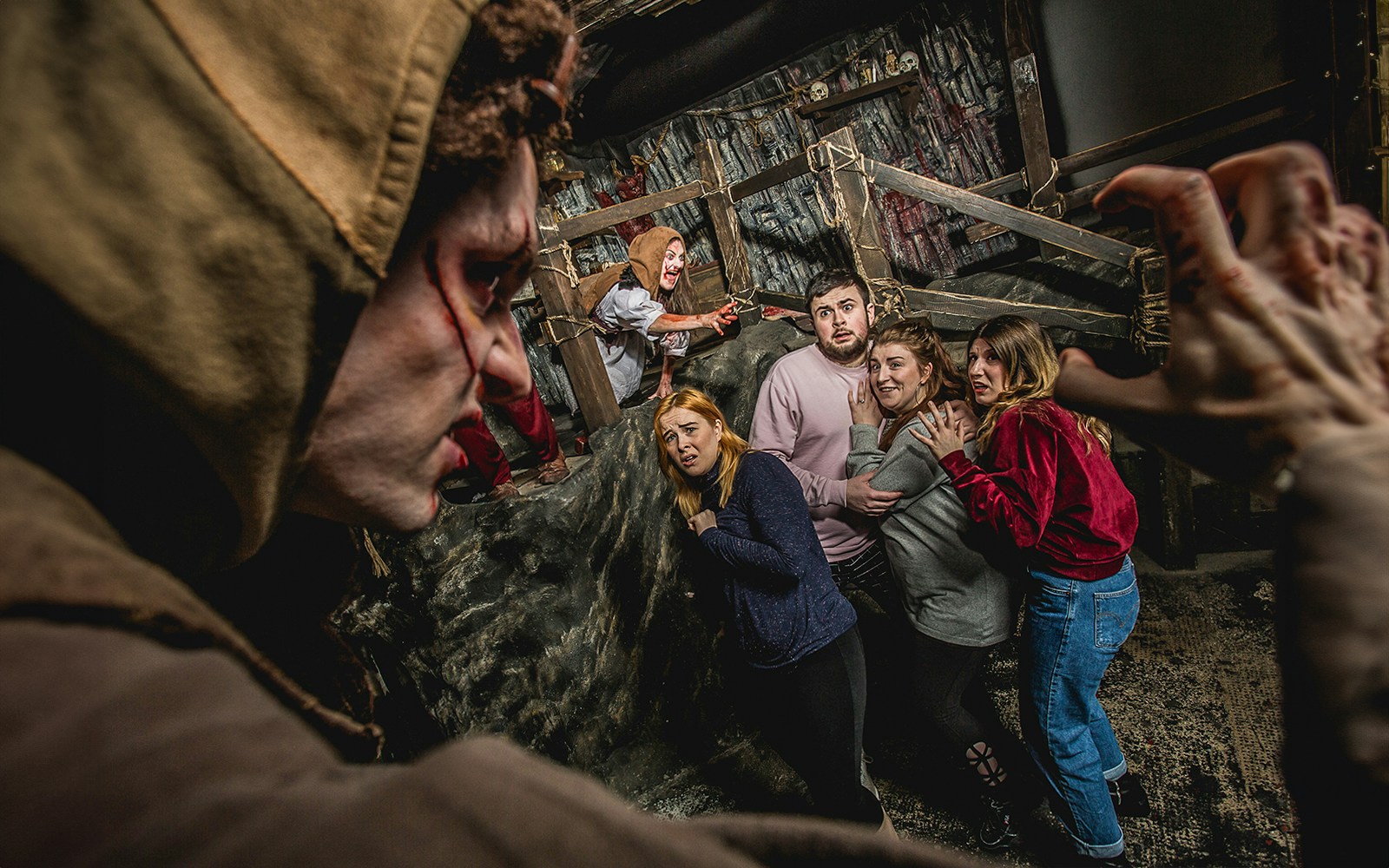 Visitors react in fear during the Edinburgh Dungeon Cannibal Clan experience.
