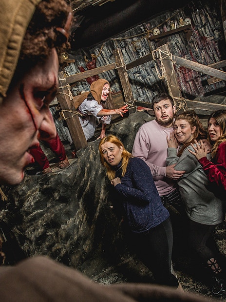 Visitors react in fear during the Edinburgh Dungeon Cannibal Clan experience.