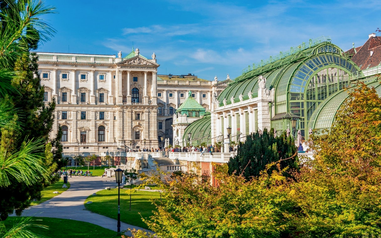 Courtyard view of Hofburg Palace complex with historic architecture and garden in Vienna.