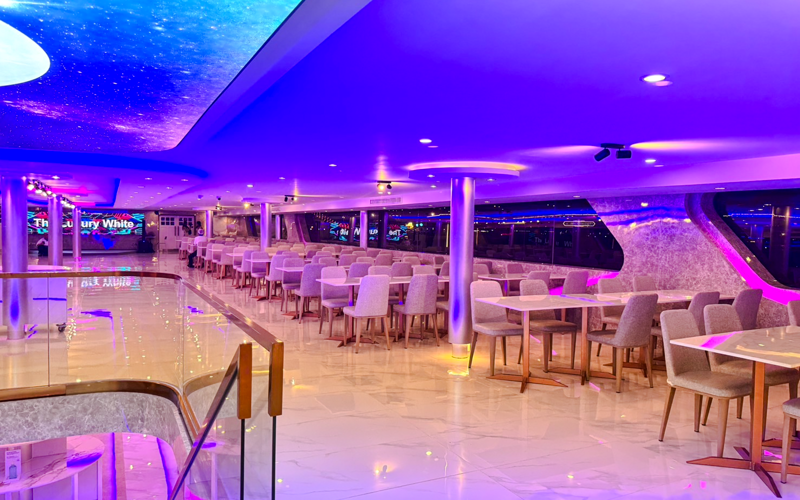 Luxury White Cruise ship interior with elegant dining area and panoramic ocean views.