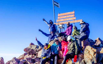 Group of hikers at the summit of Mt Kenya during a day tour from Nairobi.