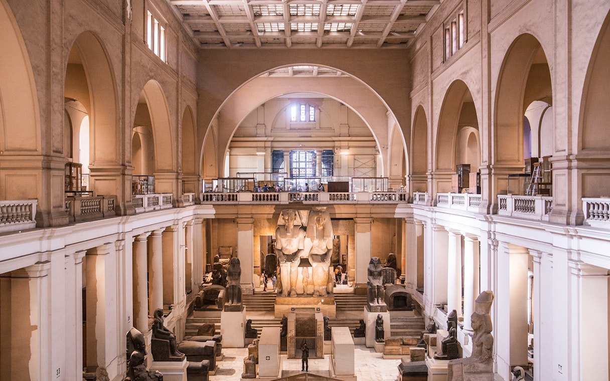 Interior of the Egyptian Museum in Cairo with ancient statues and artifacts.