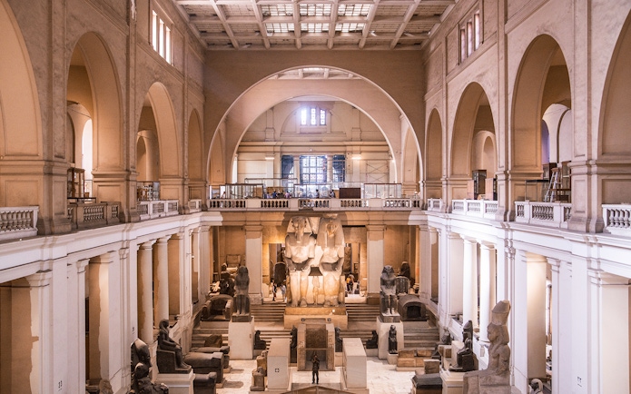 Interior of the Egyptian Museum in Cairo with ancient statues and artifacts.