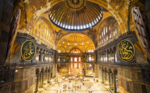 Interior of Hagia Sophia, Istanbul, showcasing ornate domes and calligraphy, related to kebab and dervish tours.