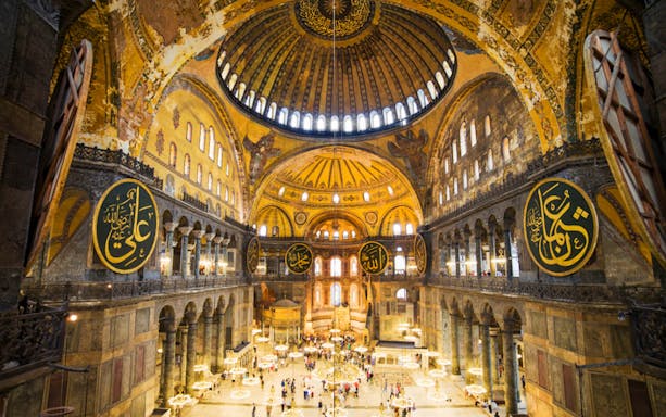 Interior of Hagia Sophia, Istanbul, showcasing ornate domes and calligraphy, related to kebab and dervish tours.
