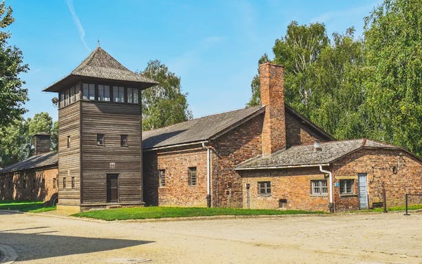 Auschwitz-Birkenau brick buildings and watchtower on guided tour from Kraków.