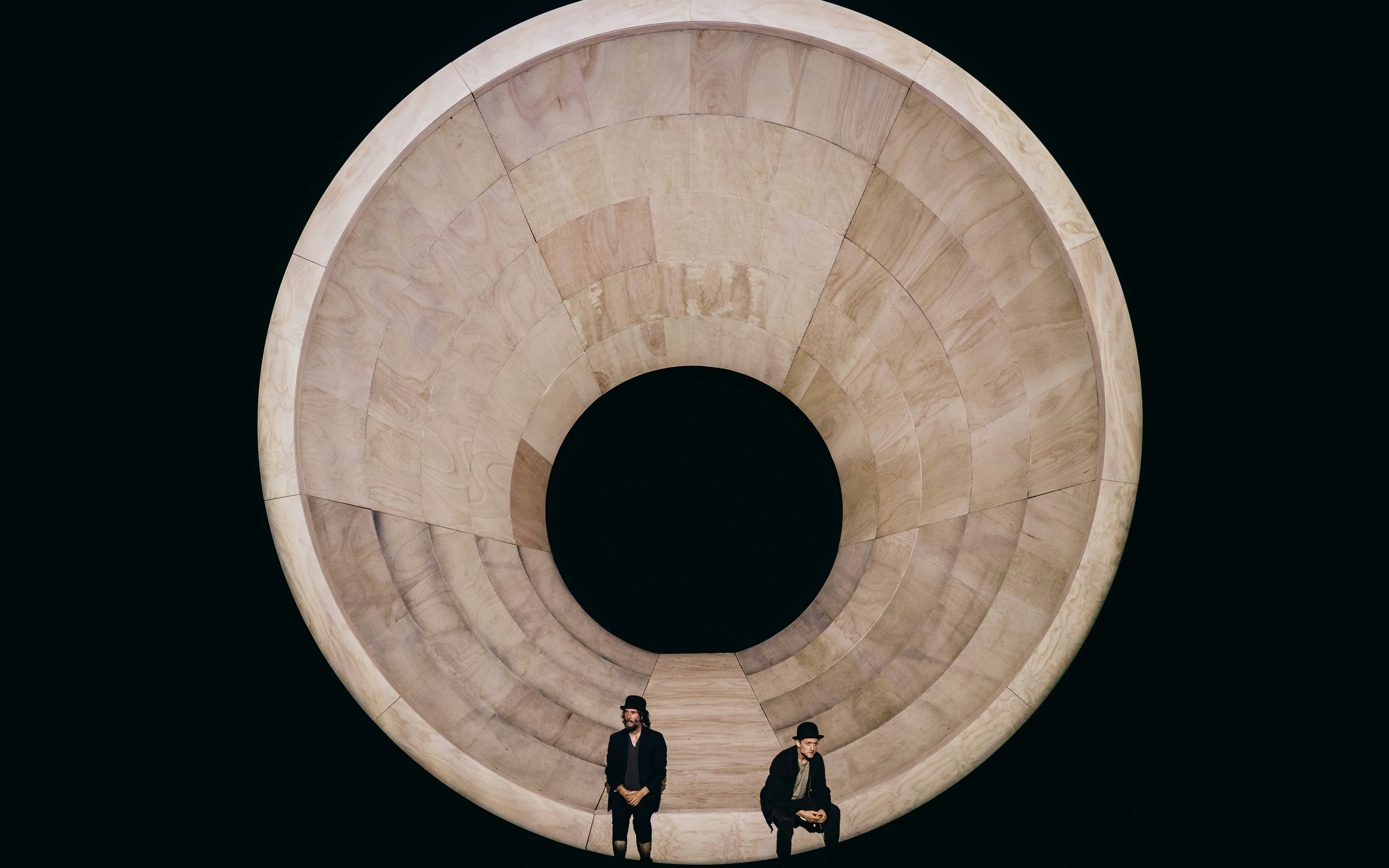 Actors on stage during Waiting for Godot Broadway show with large circular set design.