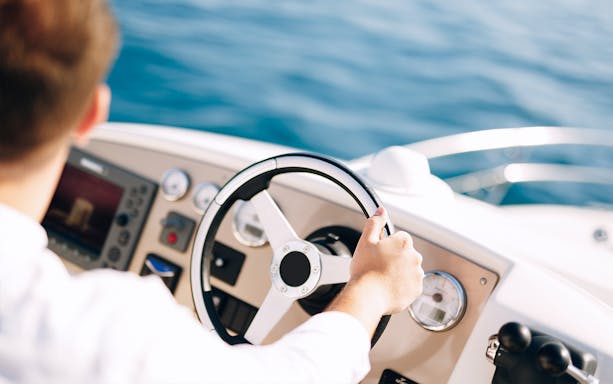 Steering a boat on a guided tour in Dubai.