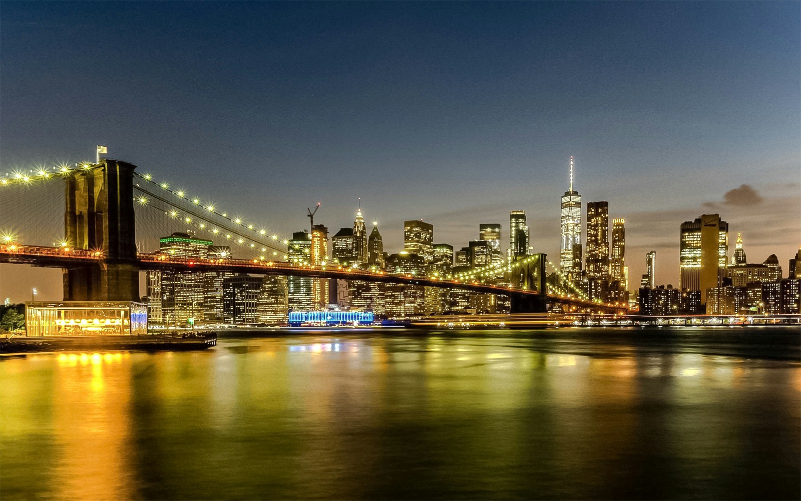 Statue of Liberty and Ellis Island at sunset during a cruise in New York Harbor.