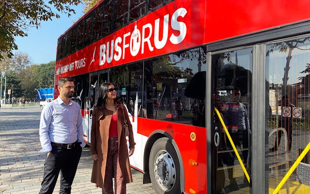 Hop-on hop-off bus tour in Istanbul with passengers boarding.