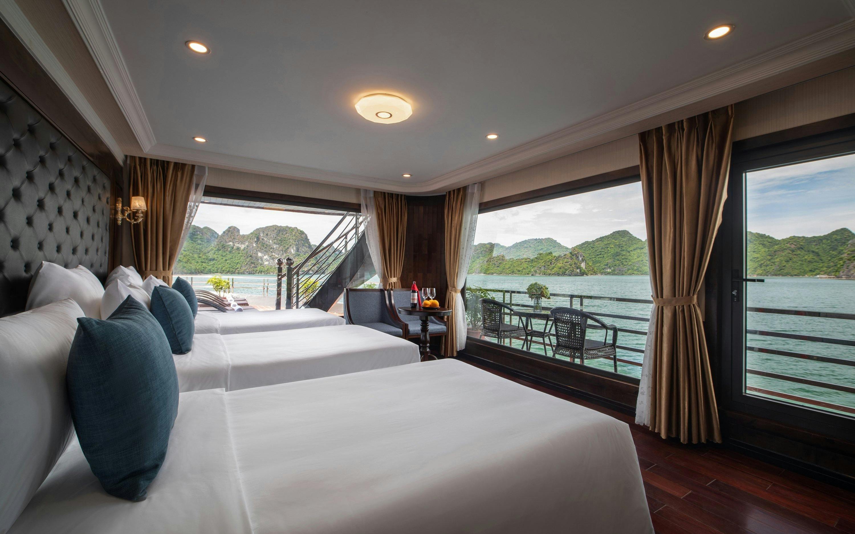 Cruise cabin with twin beds and ocean view in Lan Ha Bay.