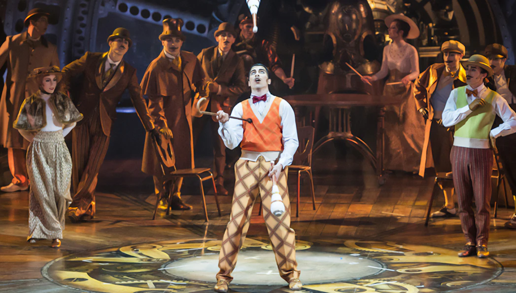 Performer juggling clubs on stage at Cirque du Soleil: Kurios West End.