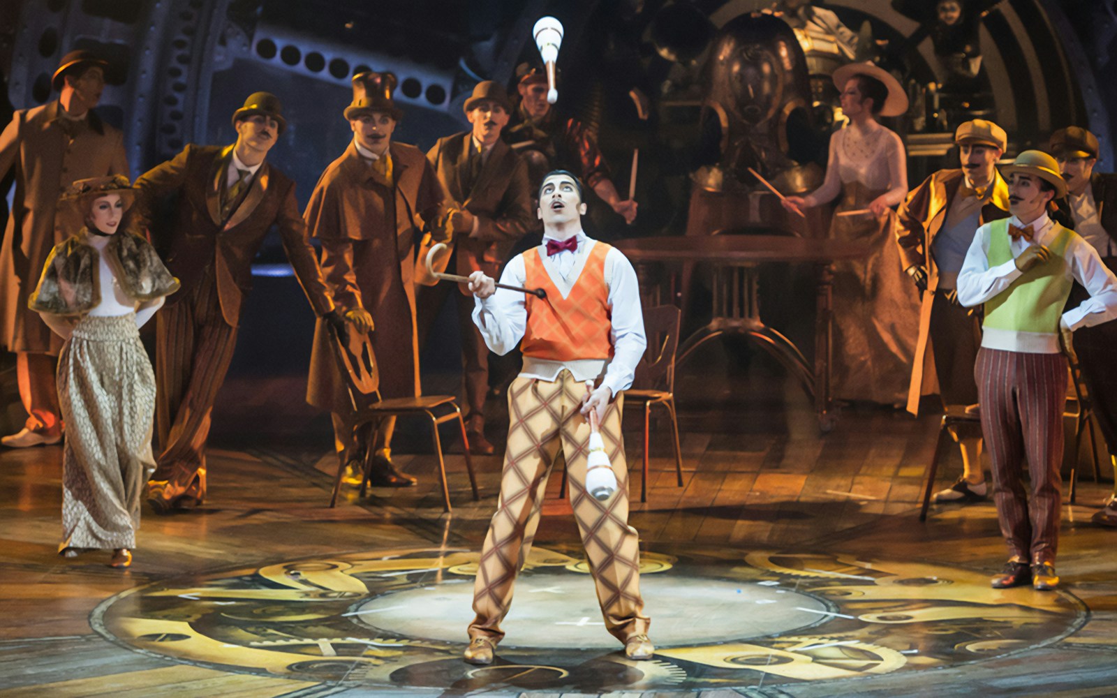 Performer juggling clubs on stage at Cirque du Soleil: Kurios West End.