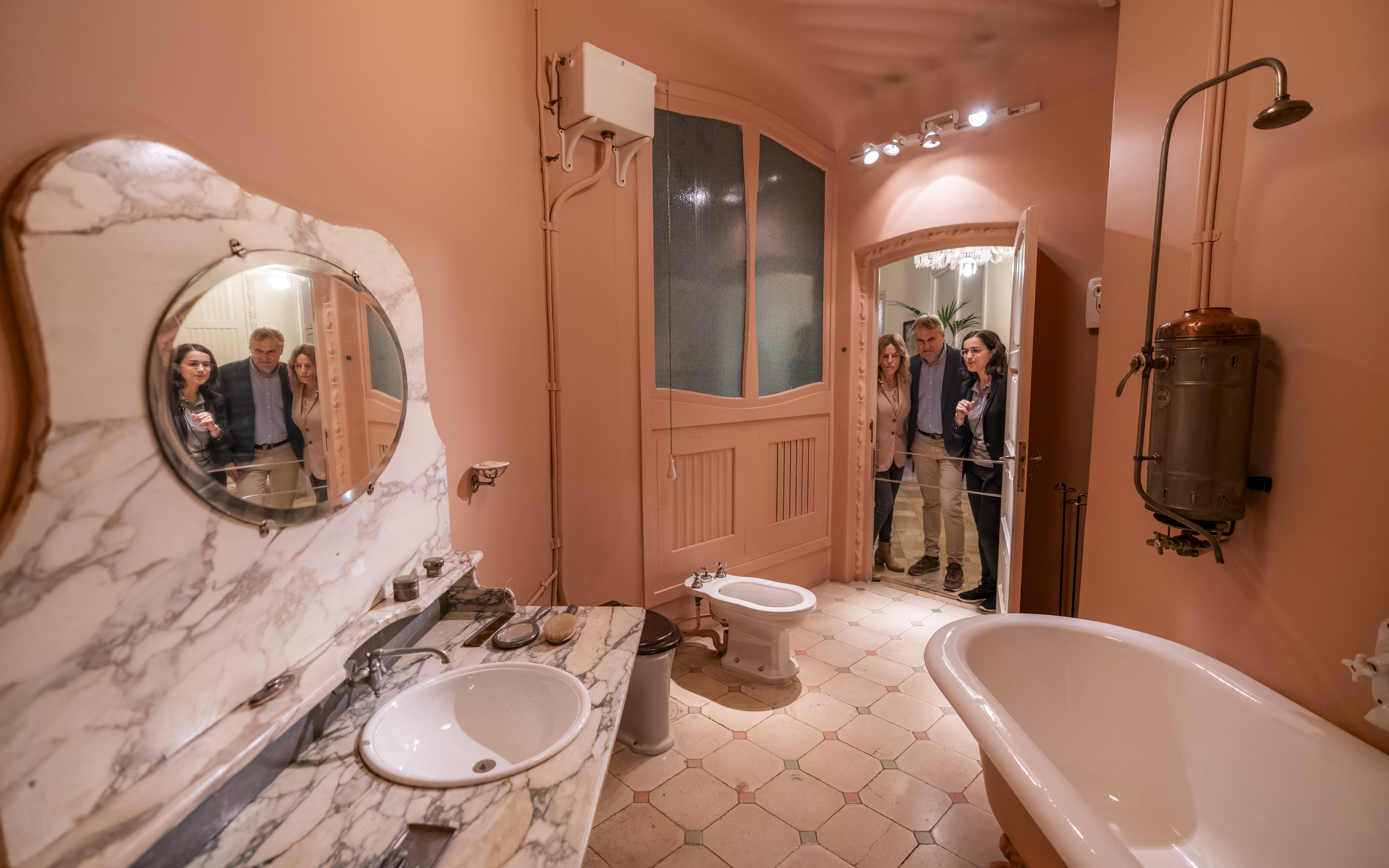 Tourists with guide in Casa Mila washroom, Barcelona.