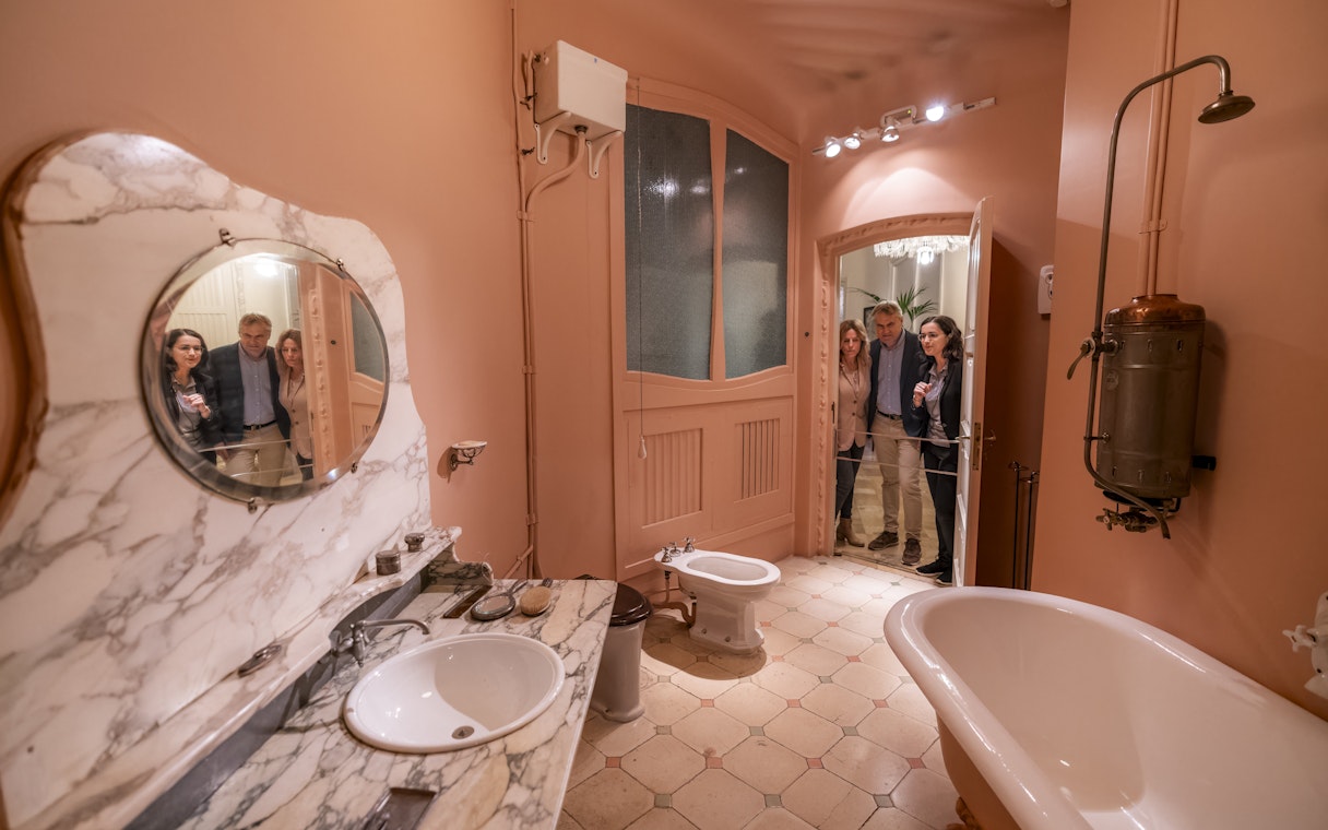 Tourists with guide in Casa Mila washroom, Barcelona.