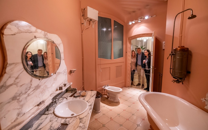 Tourists with guide in Casa Mila washroom, Barcelona.