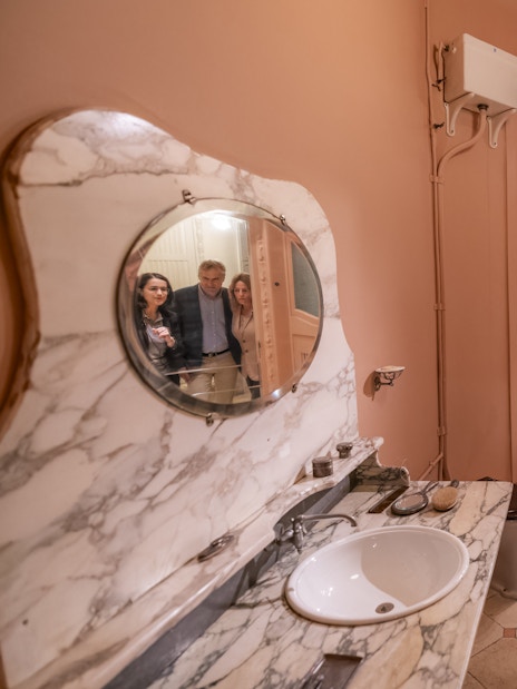Tourists with guide in Casa Mila washroom, Barcelona.