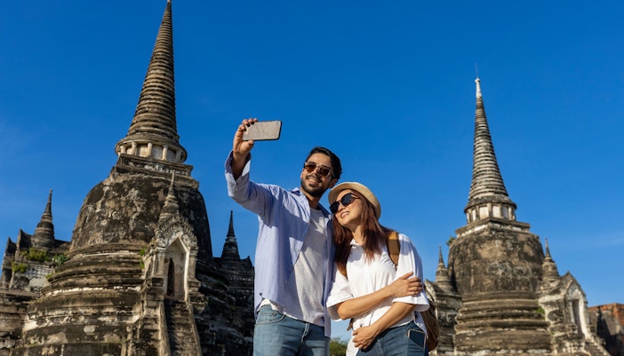 Tourists taking a selfie at Wat Phra Si Sanphet, Ayutthaya, Thailand.