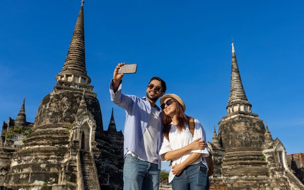 Tourists taking a selfie at Wat Phra Si Sanphet, Ayutthaya, Thailand.