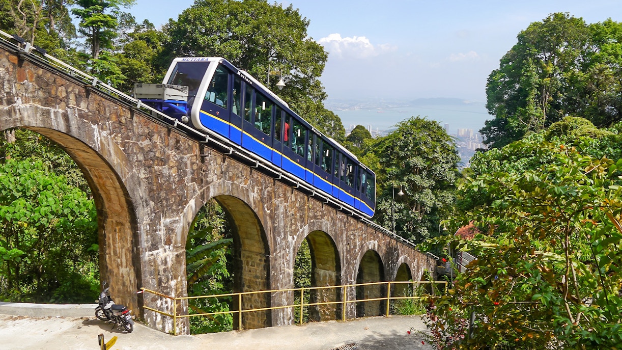 Tourists enjoying a scenic ride on the Penang Hill Funicular Train in Malaysia
