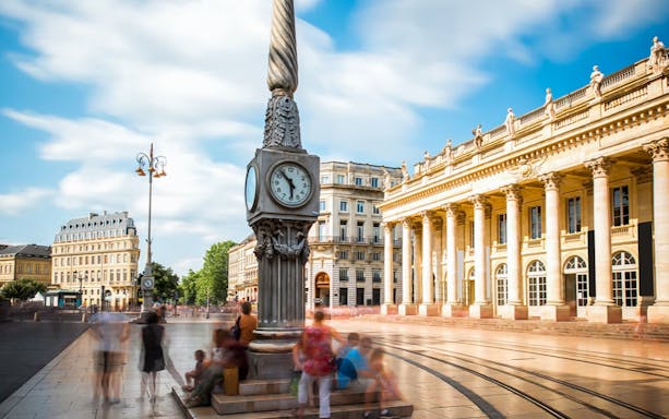Clock tower and Grand Théâtre in Bordeaux Old Town during city exploration game.