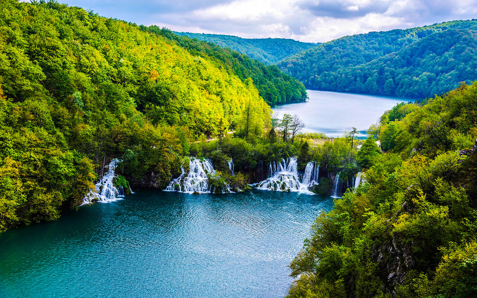 Plitvice Lakes waterfalls and lush forest view during private day tour from Split.