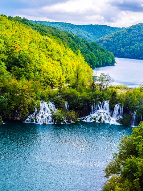 Plitvice Lakes waterfalls and lush forest view during private day tour from Split.