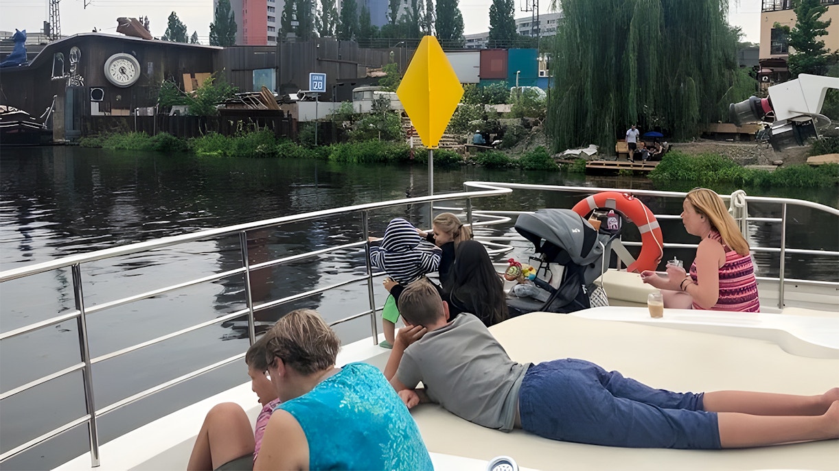 Guests relaxing on a solar catamaran during the Berlin city highlights tour along the river.