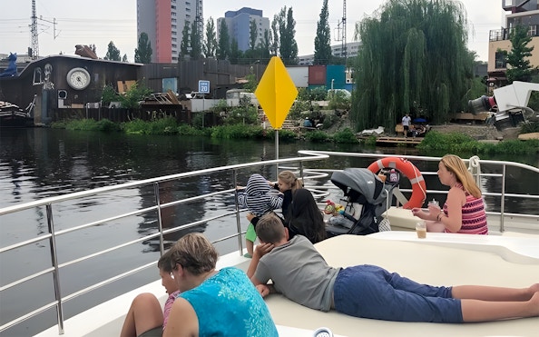 Guests relaxing on a solar catamaran during the Berlin city highlights tour along the river.