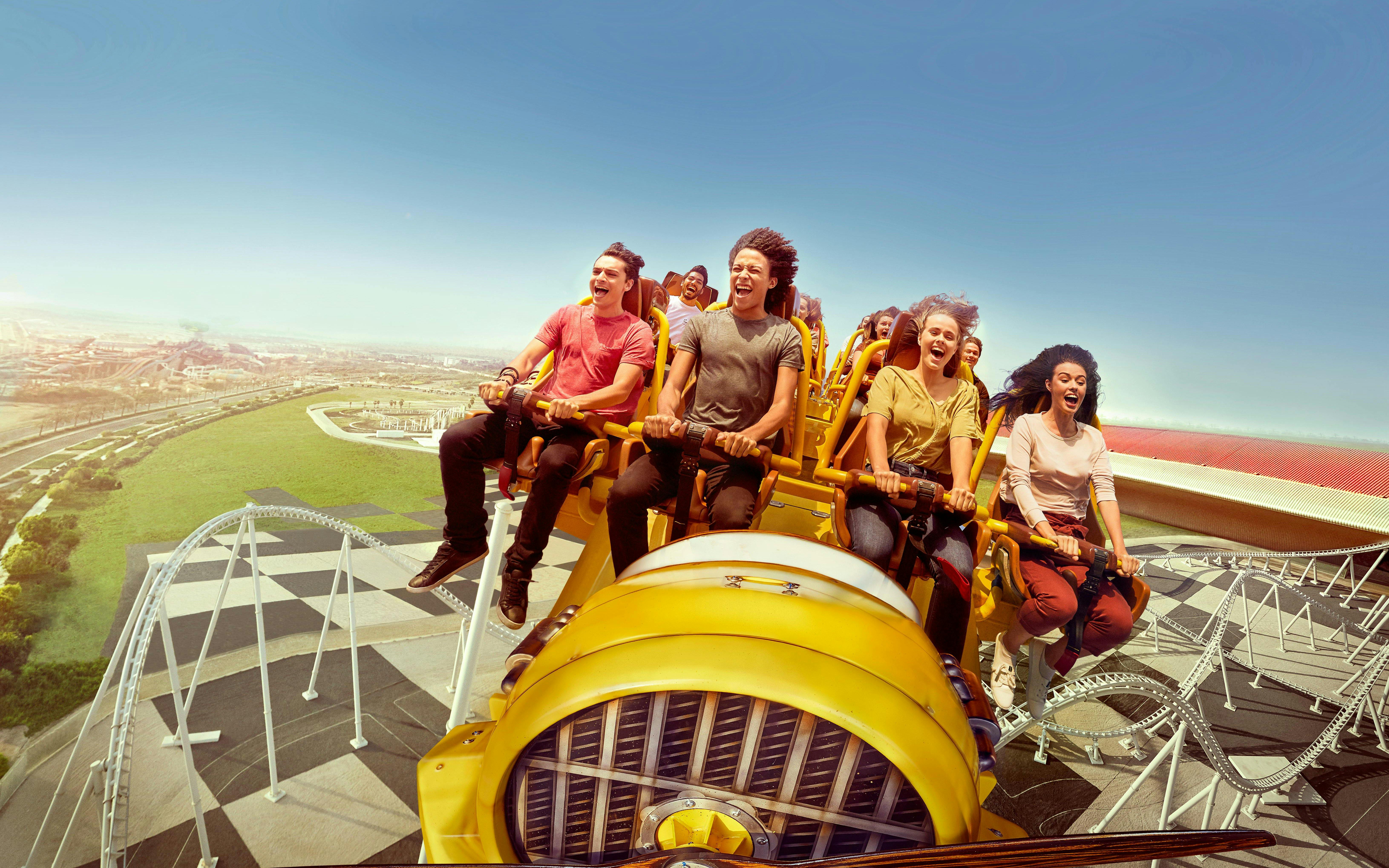 Visitors enjoying a roller coaster ride at Ferrari World Abu Dhabi.