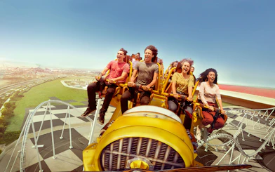 Visitors enjoying a roller coaster ride at Ferrari World Abu Dhabi.