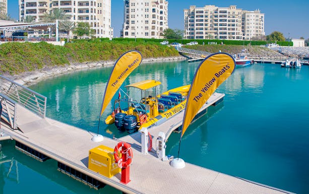 Speed boat docked at Al Marjan Island marina, ready for 45-minute tour.