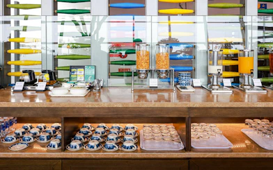 Breakfast buffet at SH Premium Lounge, Noi Bai International Airport, featuring cereals and beverages.
