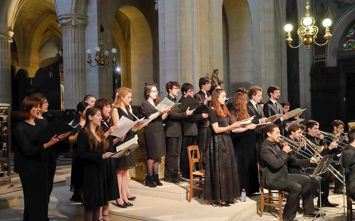 Choir and musicians performing inside Church of St Madeleine, Paris, France.