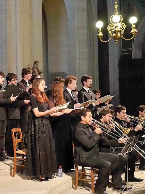 Choir and musicians performing inside Church of St Madeleine, Paris, France.