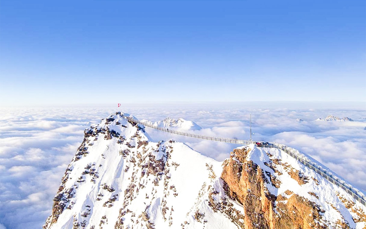 Suspension bridge over snowy peaks at Glacier 3000, Les Diablerets, Switzerland.