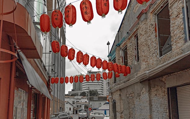 Red lanterns hanging in a Kuala Lumpur street during a 4-hour guided nightlife food tour.