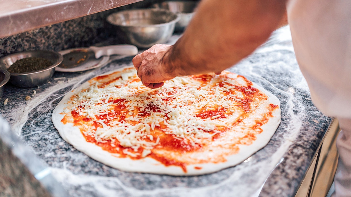 Chef preparing pizza on Dubai Creek Luxury Dhow Dinner Cruise.