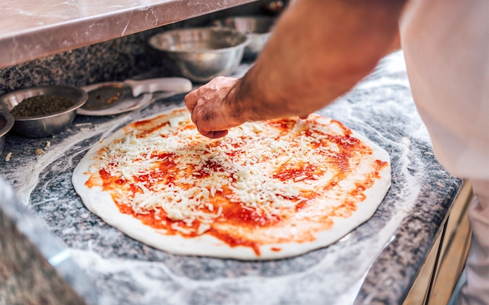 Chef preparing pizza on Dubai Creek Luxury Dhow Dinner Cruise.