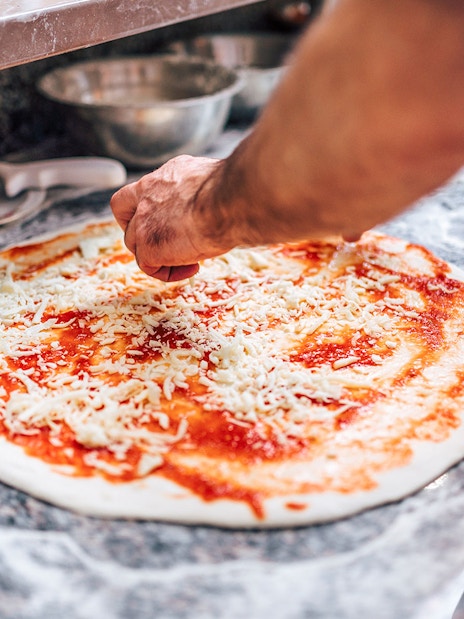 Chef preparing pizza on Dubai Creek Luxury Dhow Dinner Cruise.