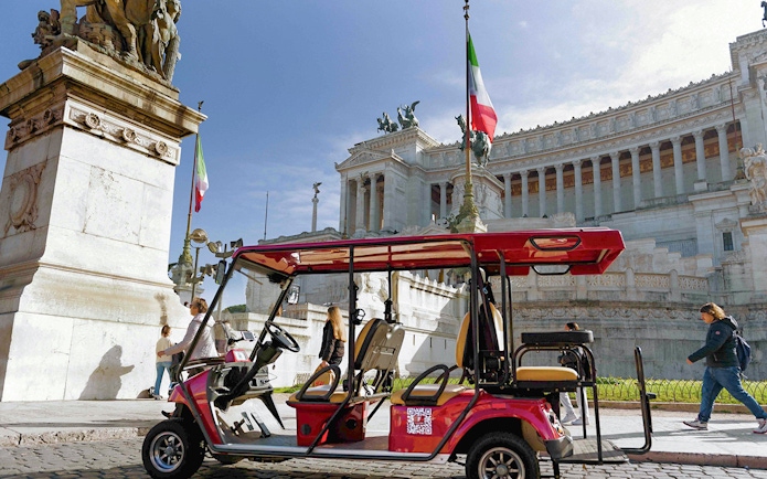 Golf cart near Altare della Patria in Rome during tour.