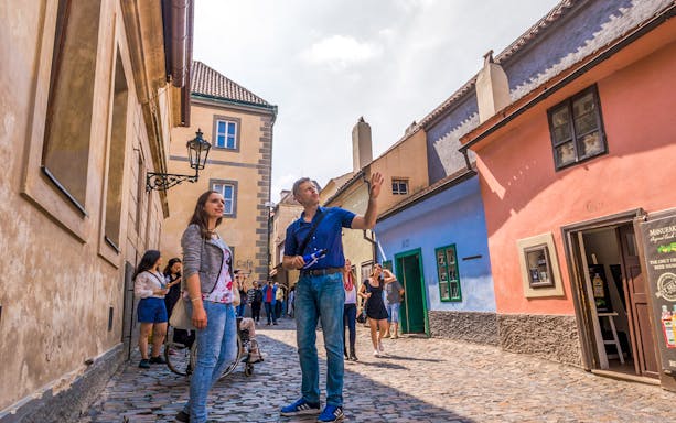 Tourists exploring Golden Lane during Prague Castle guided tour.