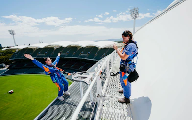 Participants on the Adelaide Oval roof climb with view of the stadium below.