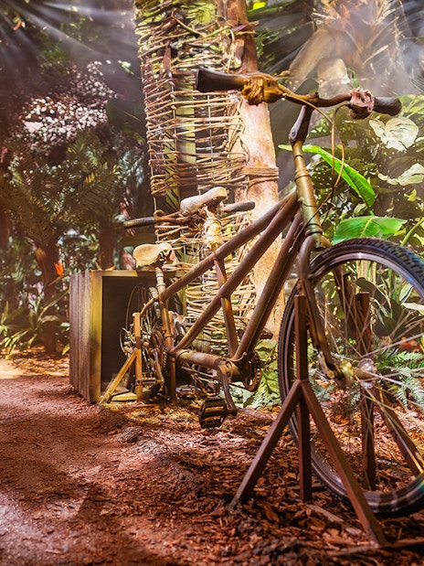 Tandem bicycle in a jungle-themed Peru setup at the Paddington Experience.