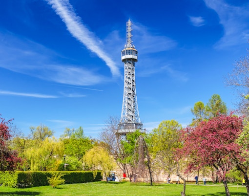 Petrin Lookout Tower in Prague with cityscape view in the background.