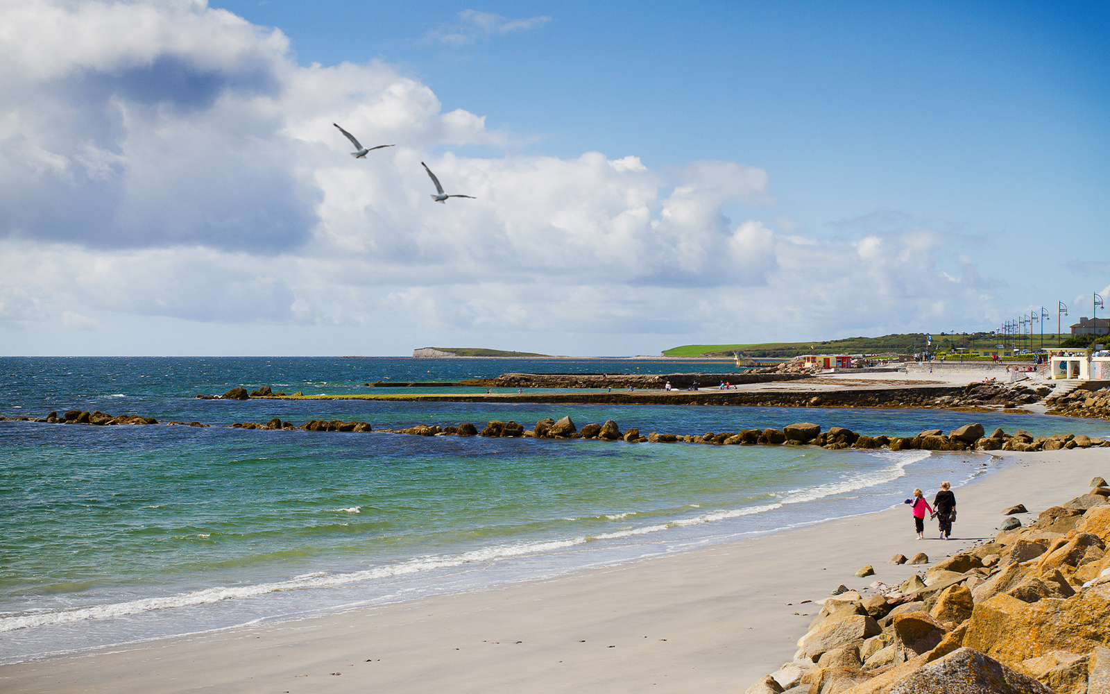 Visitors exploring Salthill Promenade. seashore Galway